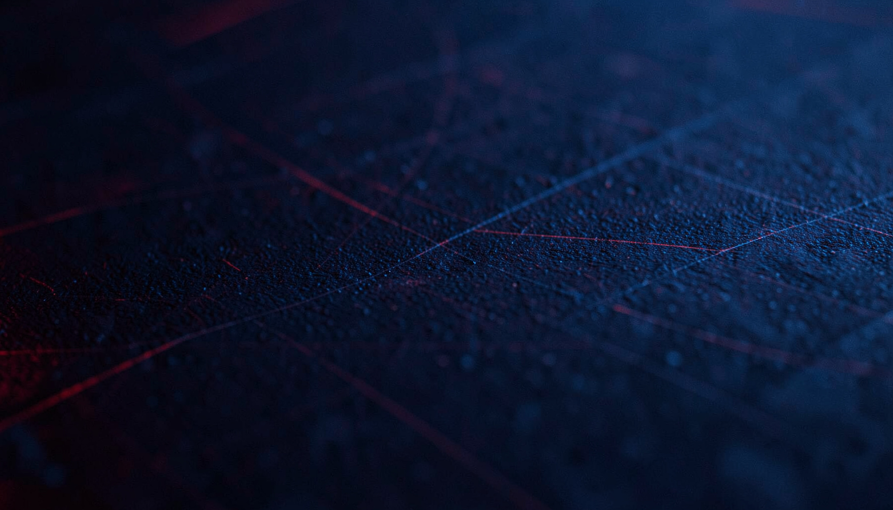 Dark abstract texture with subtle grid lines and a deep navy-blue gradient, evoking a technical digital workspace.